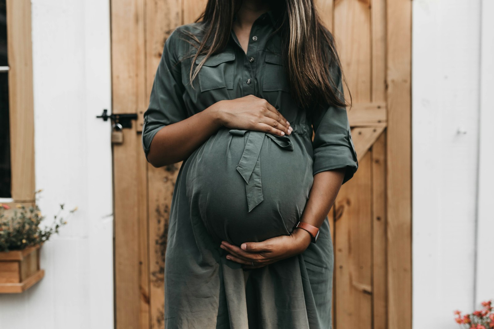 An expectant mother cradling her belly
