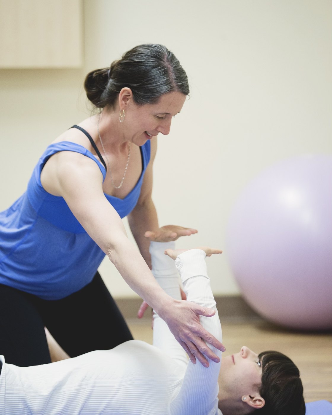 A physiotherapist guiding a client through core and pelvic floor work