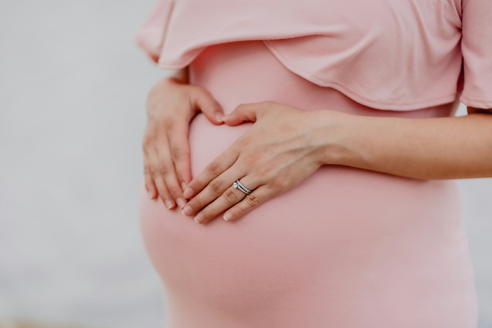 An expectant mother cradling her belly